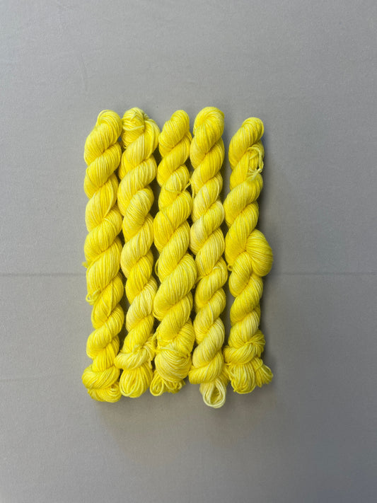 20g Sock weight mini skeins in colourway Lemon. A semi-solid colourway of pale yellow colour.