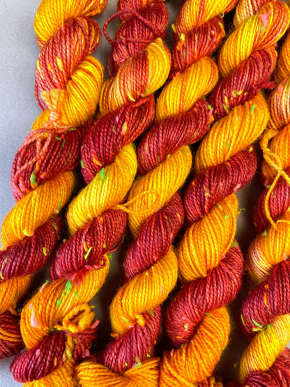 Hand-dyed Yarn
5 x 20g twisted, 4ply Neon Neps mini skeins in colourway Phoenix, photographed on light grey background. This colourway is full of tones of Golden Poppy, Ruby Red and Saffron with pops of Neon colour from the Neps.