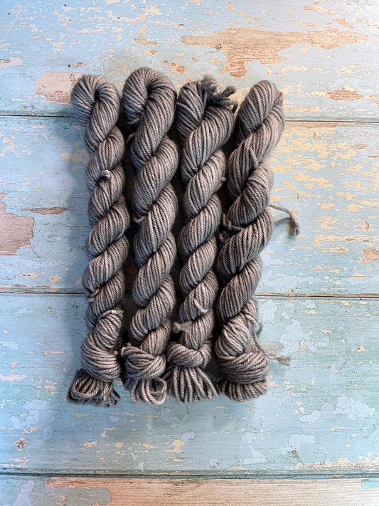 Full shot of 20g DK weight mini skeins in semi-solid colourway Grey. This colourway is a rich silver, grey colour.