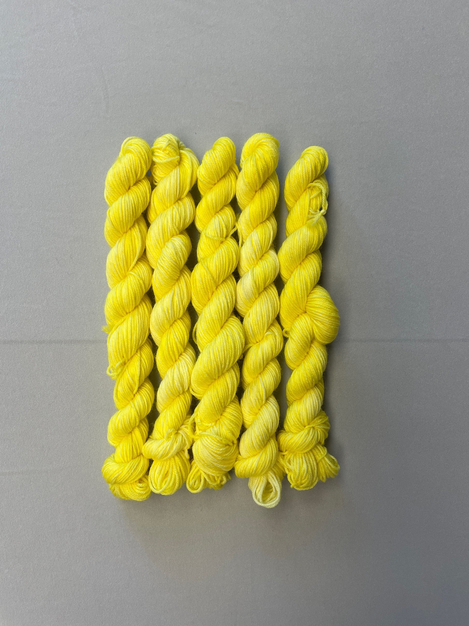 20g Sock weight mini skeins in colourway Lemon. A semi-solid colourway of pale yellow colour. 