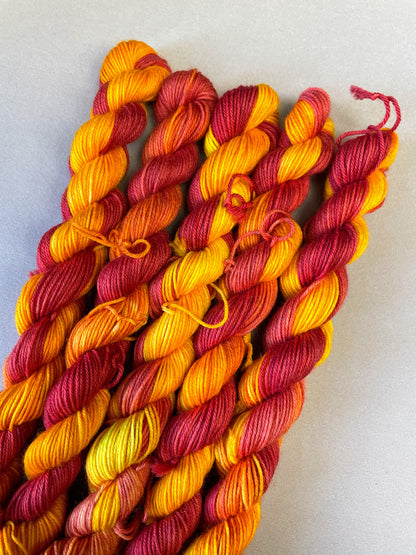 Hand-dyed Yarn
5 x 20g twisted, Sock mini skeins in colourway Phoenix, photographed on light grey background. This colourway is full of tones of Golden Poppy, Ruby Red and Saffron.